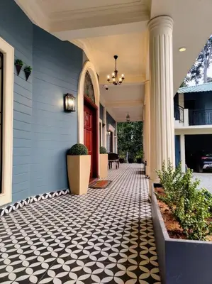 a hallway of a house with a red door at Villa Forever Coorg in Madikeri