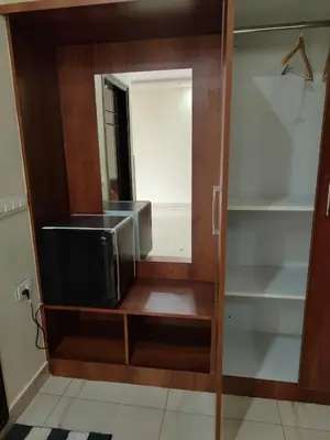 a mirror and a tv in a room at Dkgardenia24 in Kanakapura