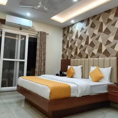 a bedroom with a large bed and a window at Dkgardenia24 in Kanakapura