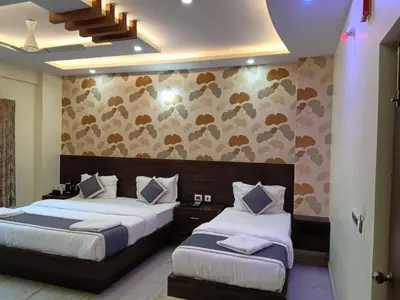 a bedroom with two beds and a wall at Dkgardenia24 in Kanakapura