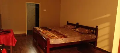 a bedroom with a bed in a room at Hornbill Castle in Vālpārai