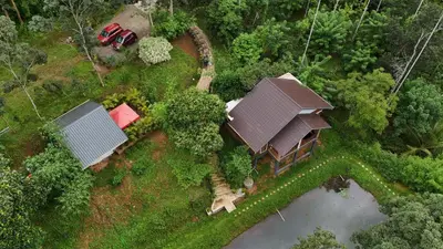 an aerial view of a house with a tractor at Casta Wild Resort in Batheri