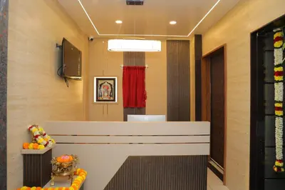 a waiting room with a counter and a red curtain at Hotel BR Grand in Coimbatore