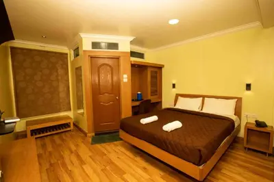 a bedroom with a bed with two towels on it at Lazo Silver Lake , Ooty in Ooty