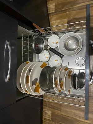 a rack with plates and pans in an oven at Jk homestay Mysore in Mysore