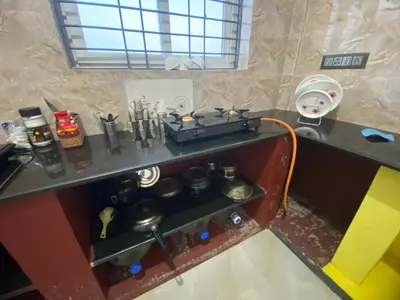 a toy kitchen with a stove and some pots and pans at Jk homestay Mysore in Mysore