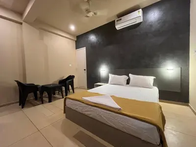 a bedroom with a bed and a table and chairs at Rocks beach house in Kannur