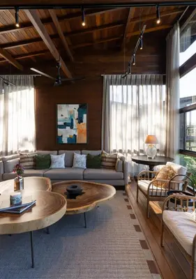 a living room with a couch and a table at LohonoStays Amani Villa 9A in Coonoor