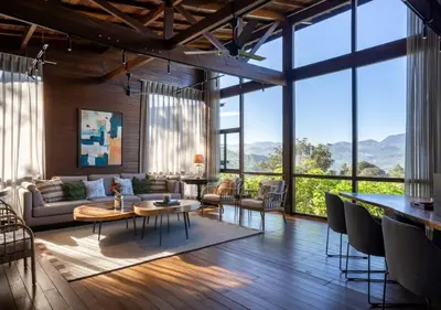 a living room with a lot of windows at LohonoStays Amani Villa 9A in Coonoor