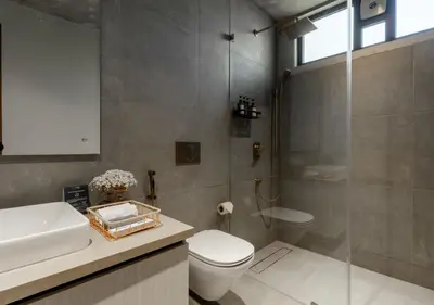 a bathroom with a shower and a toilet and a sink at LohonoStays Amani Villa 9B in Coonoor