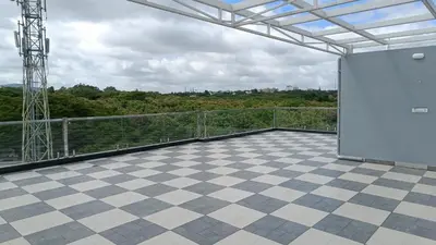 a balcony with a checkered floor and a view at Eve Service apartment in Mysore