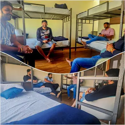 a group of people sitting in bunk beds at Beedu - Backpackers Hostel in Mysore