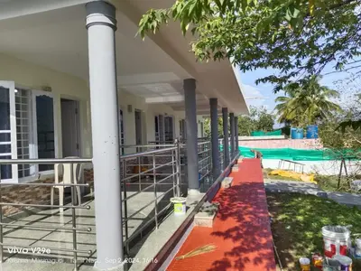 a porch of a house with a swimming pool at Alappat Lodge Masinagudi in Masinagudi