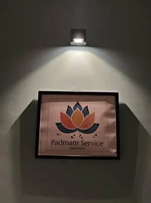 a sign for a pakistani service hanging on a wall at Padmam Service Apartments - 2BHK in Singānallūr