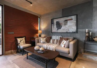 a living room with a couch and a table at LohonoStays Amani Villa 10A in Coonoor