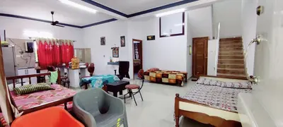 a room with several beds and chairs in it at Nature stay Mysore in Mandya