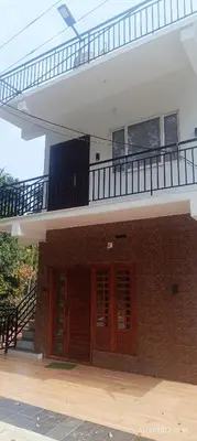 a building with two doors and a balcony at Blue mount stay in Gūdalūr