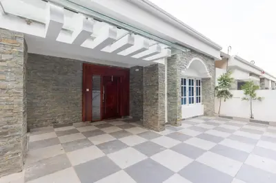 a patio of a house with a red door at Symphony in Ooty