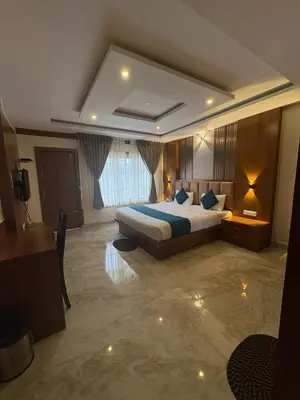 a bedroom with a large bed in a room at Symphony in Ooty