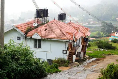 a house with red tile roofs on a hill at Ooty Horizon Heights in Ooty