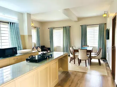 a kitchen and dining room with a table and chairs at Away From Home - 4 - Rooms In Ooty, Home Stay Ooty in Ooty