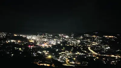 a view of a city lit up at night at Away From Home - 5 - Rooms In Ooty, Home Stay Ooty in Ooty