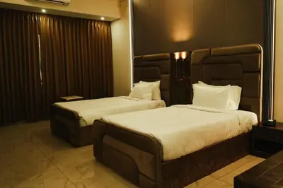 a hotel room with two beds in a room at BINI Heritage in Trichūr