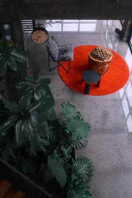 an aerial view of a living room with a red rug at Bhadra - The Estate Villa in Wayanad