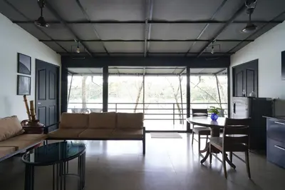 a living room with a couch and a table at Lakedale Resorts in Thekkumkara
