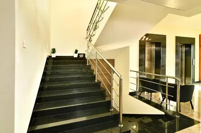 a staircase in a building with black stairs at Eka Lyf Inn in Coimbatore