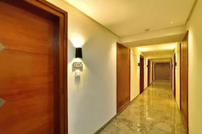 a hallway with a door and a light on the wall at Eka Lyf Inn in Coimbatore