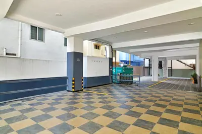 an empty hallway with a checkered floor in a building at Eka Lyf Inn in Coimbatore