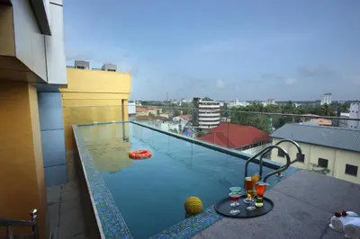 a swimming pool on top of a building at The Garuda Hotels in Trichūr