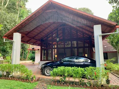 a car parked in front of a house at Cuppa Creek Homestay in Madikeri