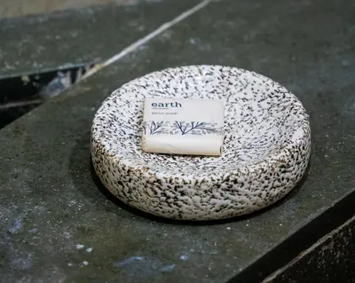 a soap sitting on top of a rock on a table at Villa Katipadu Coorg in Srimangala