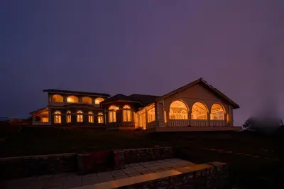 a large house lit up at night at Emerald Stays Ooty By VOYE HOMES - Italian Luxury near Ooty Emerald Lake in Ooty