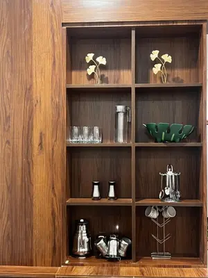 a wooden shelf with pots and pans on it at Sahar Home Stay 01 in Mysore