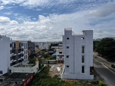a white building on the side of a city at Sahar Home Stay 01 in Mysore