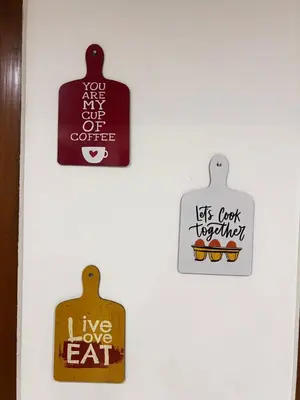 four signs on a white door with words on it at Sahar Home Stay 01 in Mysore