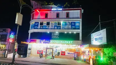 a building with neon signs in front of it at moona apartments in Malappuram