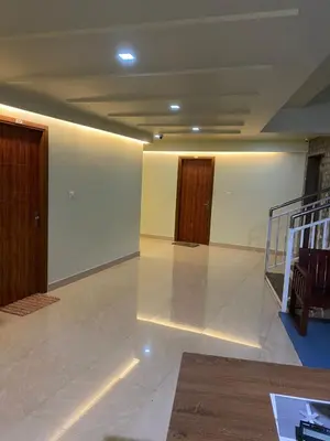 an empty room with two doors and a floor at moona apartments in Malappuram