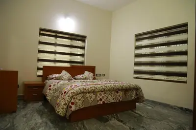 a bedroom with a bed and two windows at 3 BHK HOUSE with nice facilities,Gate&Fence in Kunnamangalam