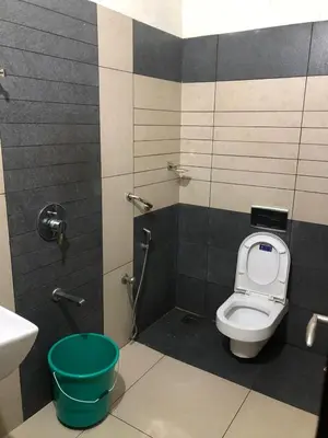 a bathroom with a toilet and a sink at 3 BHK HOUSE with nice facilities,Gate&Fence in Kunnamangalam