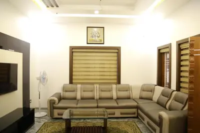 a living room with a couch and a tv at 3 BHK HOUSE with nice facilities,Gate&Fence in Kunnamangalam