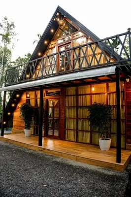 a house with two potted plants in front of it at Ethnic Villa Wayanad in Kenichira