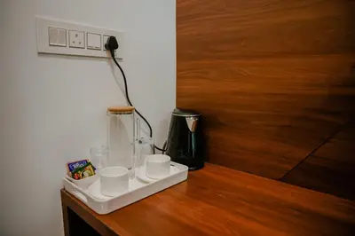 a counter with cups and a blender on a table at Ethnic Villa Wayanad in Kenichira