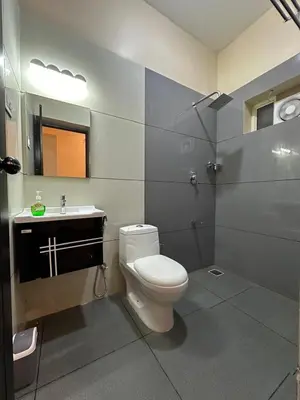 a bathroom with a toilet and a sink and a shower at Jungle Getaway Wayand in Pulpally