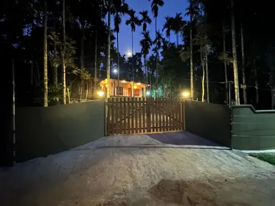 a gate in front of a house at night at Jungle Getaway Wayand in Pulpally