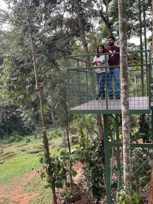 a man and woman standing on a platform in a tree house at Jungle Getaway Wayand in Pulpally