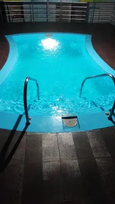 a swimming pool with a handle in the water at Hotel Afrad International in Kondotti